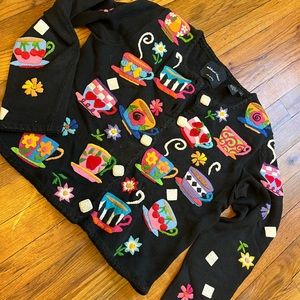 Black Michael Simon sweater with teacup and sugar cubes